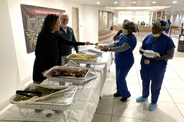 Dr. Siegel and Dr. Grand serving Temple Team members.